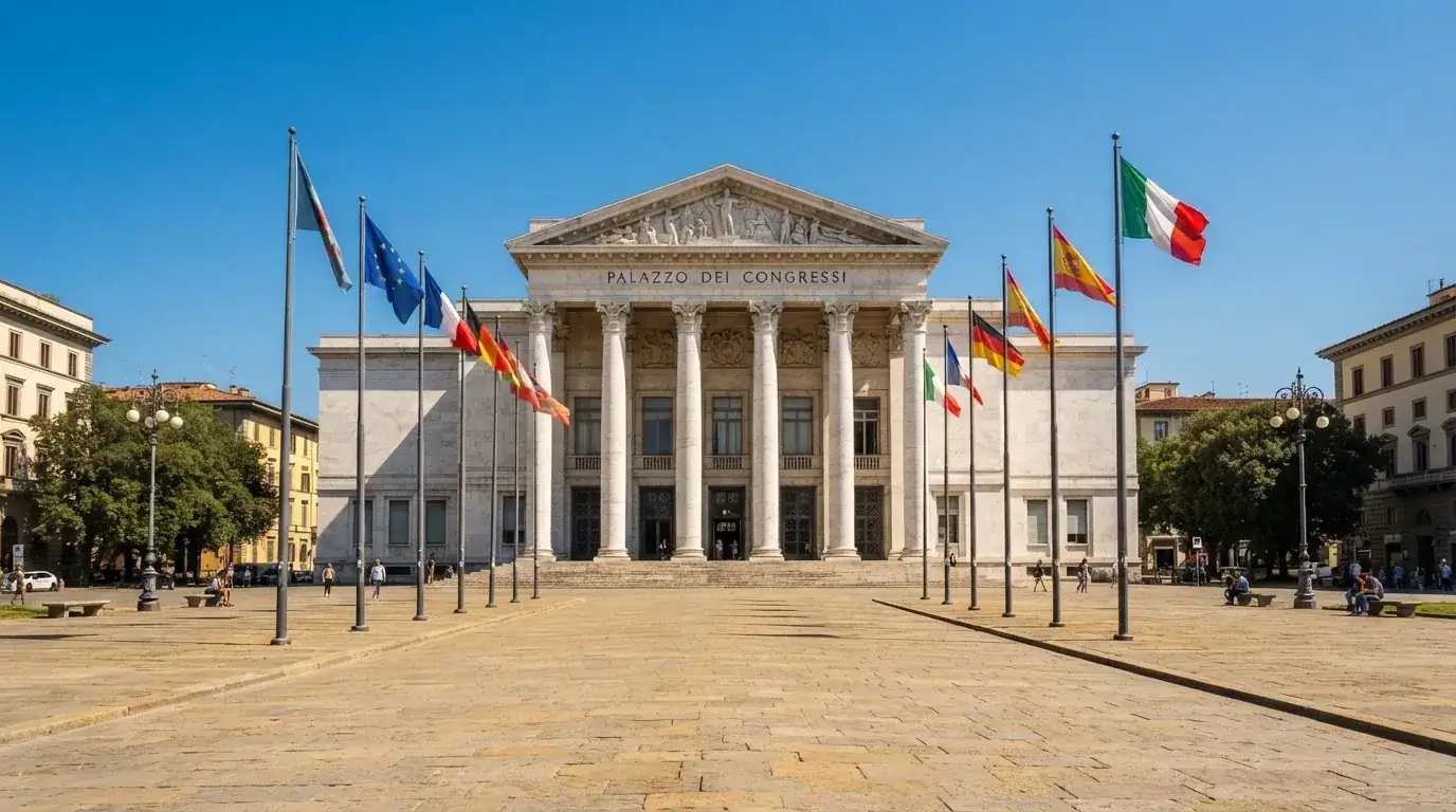 Palazzo istituzionale con bandiere al vento in una piazza soleggiata — casino deposito minimo 1 euro